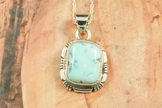 Genuine Blue Moon Turquoise set in Sterling Silver Pendant. The Blue Moon Turquoise Mine is located in Esmeralda County, Nevada. It closed in the late 1970's. Blue Moon Turquoise is now obtained from private collections. Created by Navajo Artist Jake Sampson. Signed by the artist.